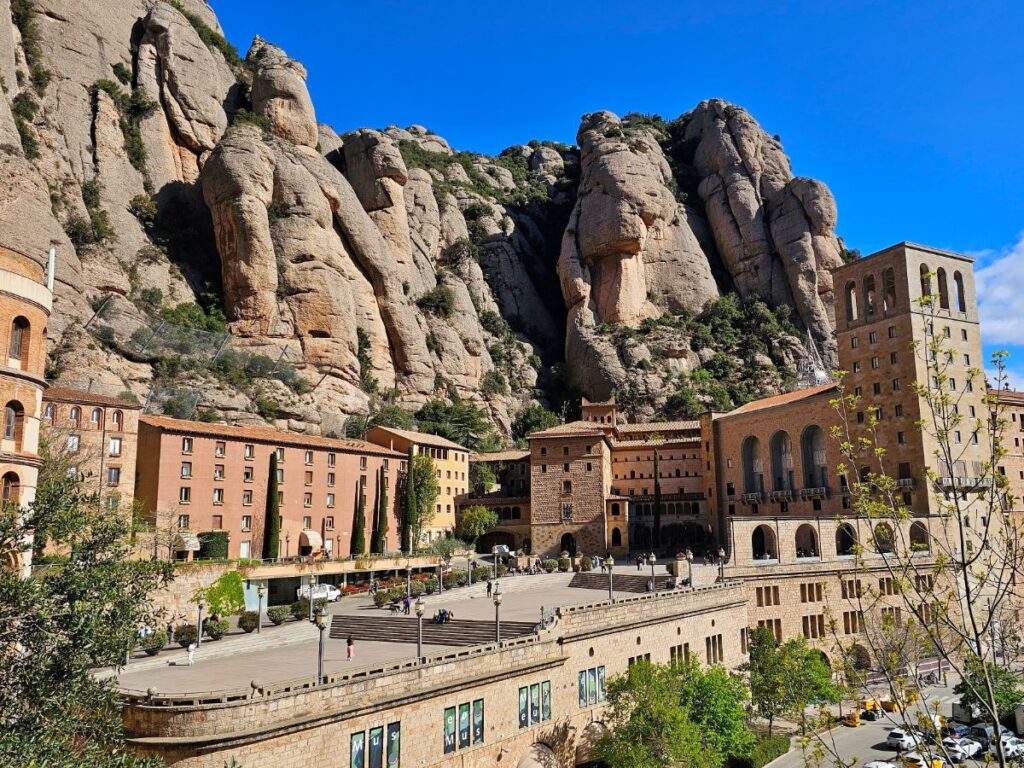 Monserrat Monastery with Serrated Mountain Peaks Behind - How to Get to Montserrat from Barcelona